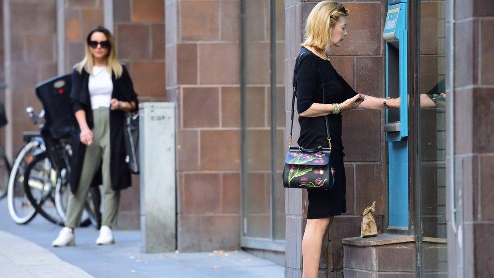 Woman at cash machine