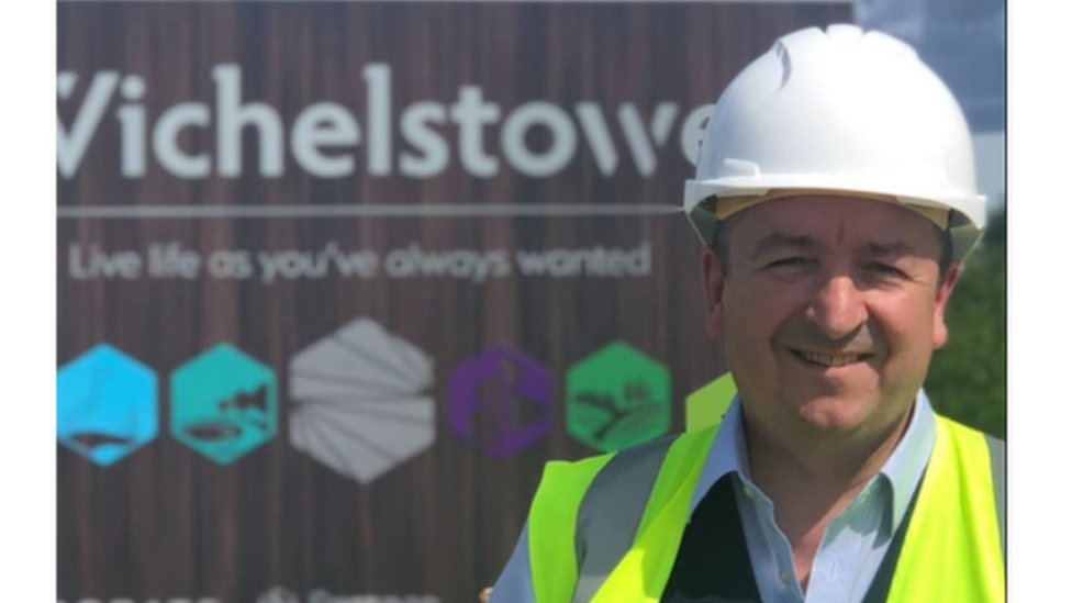 Gary Summer wearing a high visibility jacket and a hard hat.