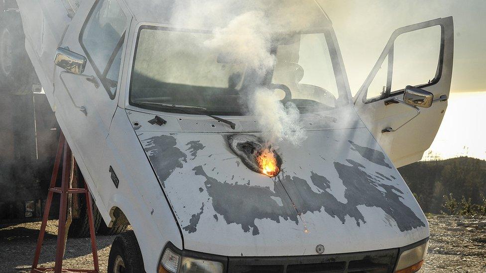 Fiery hole in bonnet of pick-up truck