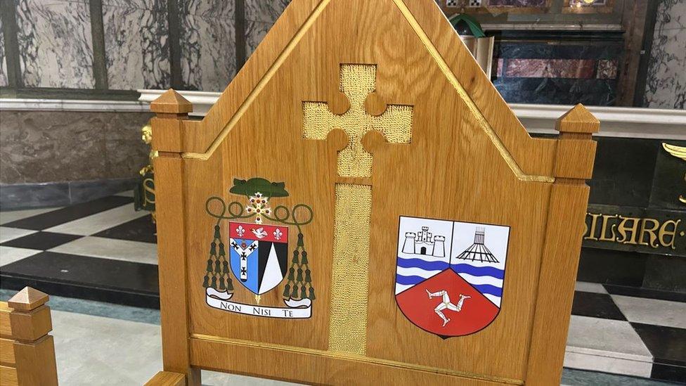 The specially designed coat of arms blending Archdiocesan and Manx symbols