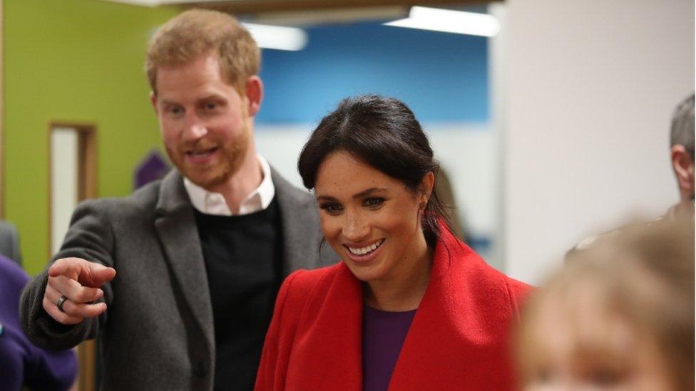 Harry and Meghan laughing at an event