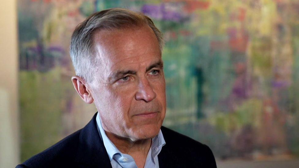 Mark Carney, Canada prime minister, speaking to the BBC in Ottawa as the polls close in the Canadian election. He is wearing a blue suit jacket with a blue shirt.