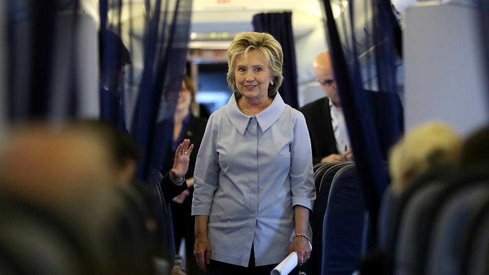 Hillary Clinton greets staff aboard her campaign plane at Westchester County Airport in New York - 5 September 2016