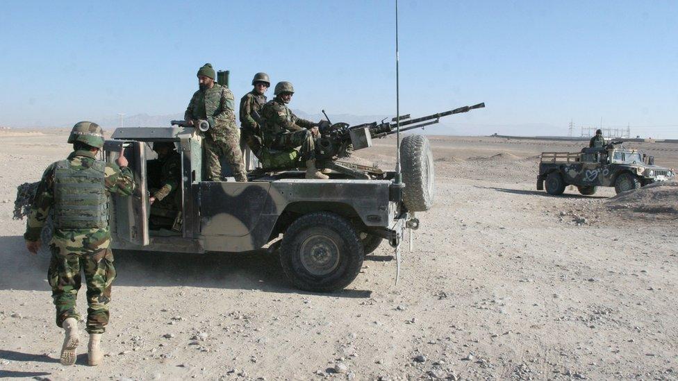 In this Wednesday, Dec. 23, 2015 file photo, Afghan National Army soldiers guard a checkpoint on the way to the Sangin district of Helmand province, Afghanistan. After months of ferocious fighting,