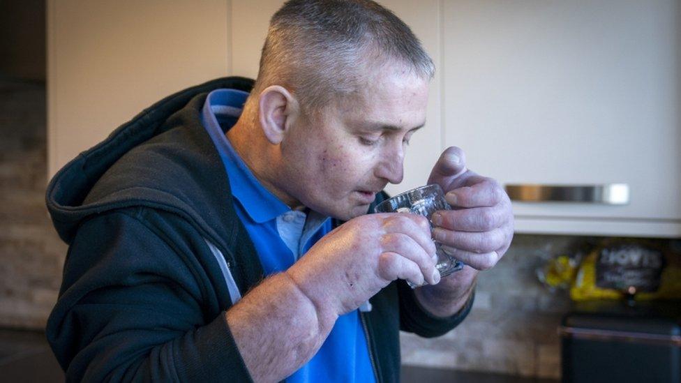 Steven Gallagher drinks a glass of water