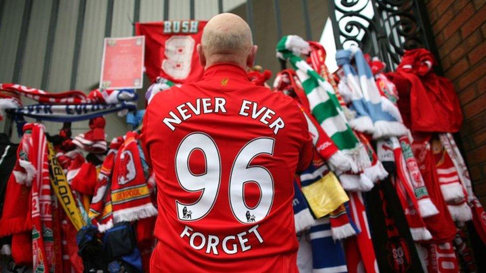 A campaigner stands outside Anfield