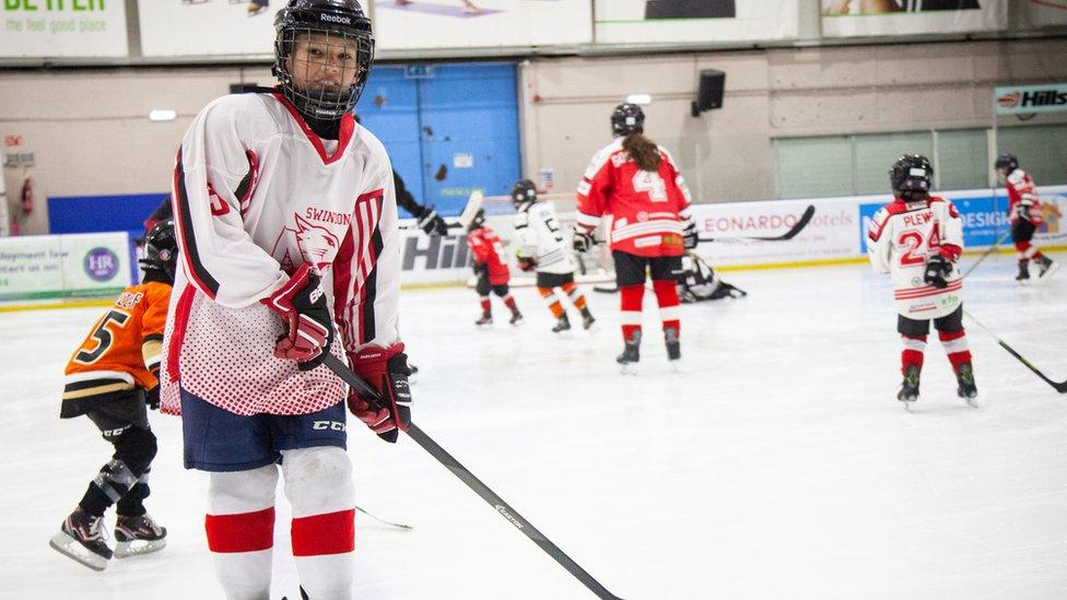 Myron on the ice with other players in the background