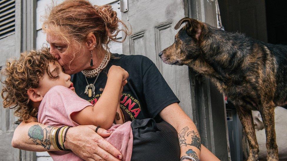 A woman comforts her grandson as the storm nears New Orleans