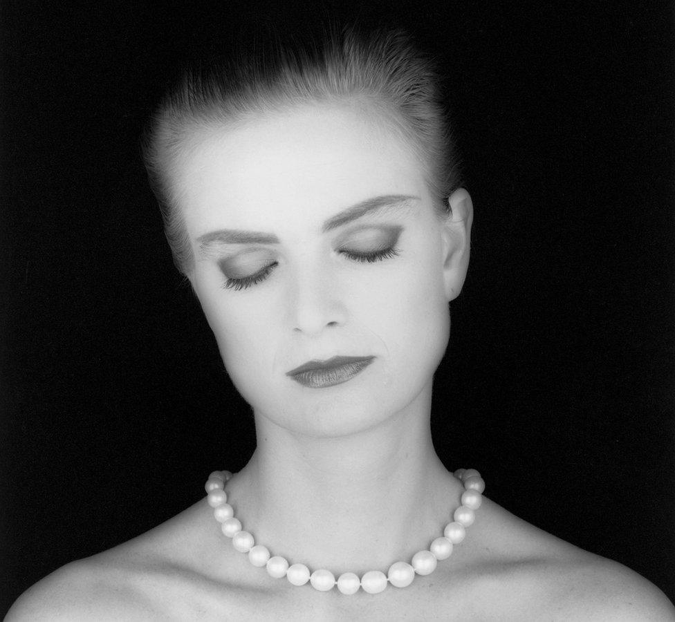 Princess Gloria von Thurn and Taxis wears a pearl necklace as she poses with her eyes closed