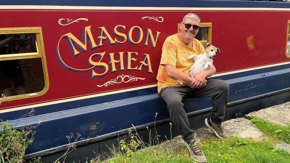 Mark on his narrow boat Mason Shea with dog Tilly