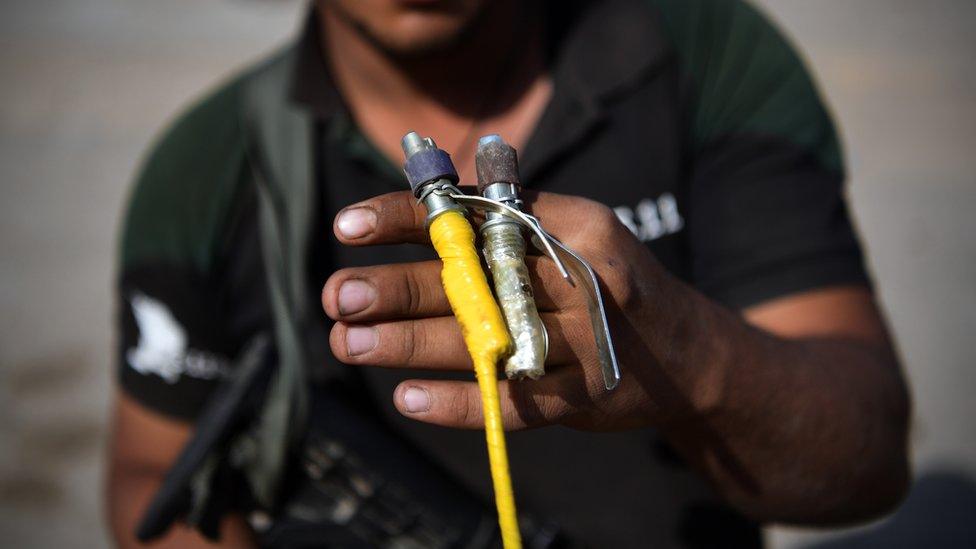 An Iraqi counter terrorism soldier holds a detonator for a bomb after making it safe during the offensive to recapture the city of Mosul from Islamic State militants, 23 October 2016