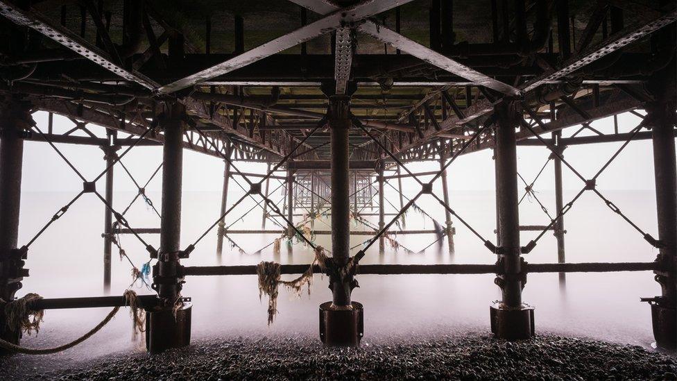 A grey and murky morning underneath Worthing Pier