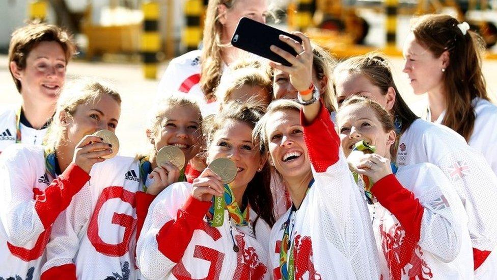 Team GB athletes pose with their medals for selfies as they return home from the 2016 Rio Olympics, at Heathrow Airport in London