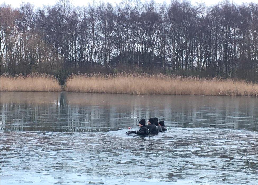 Five men in a pond