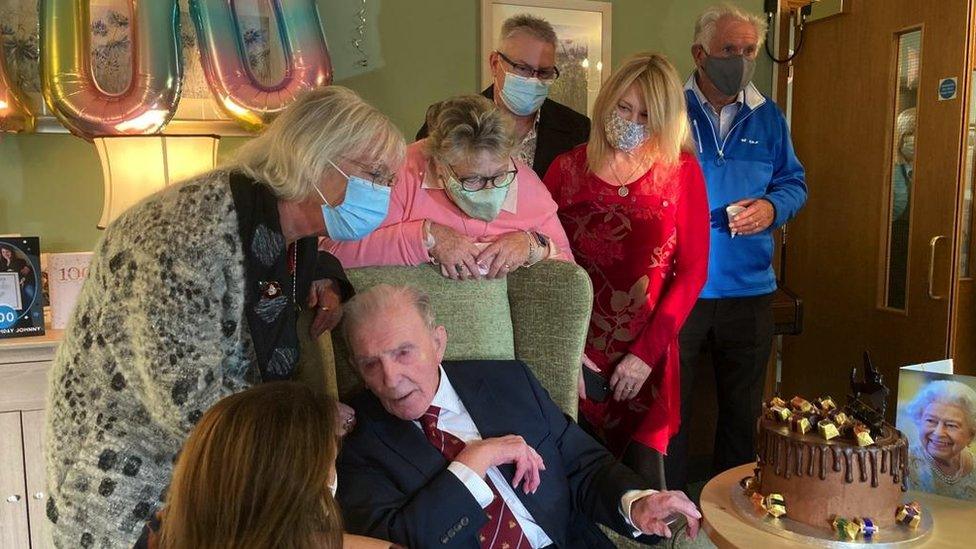 Johnny Johnson with family and cake