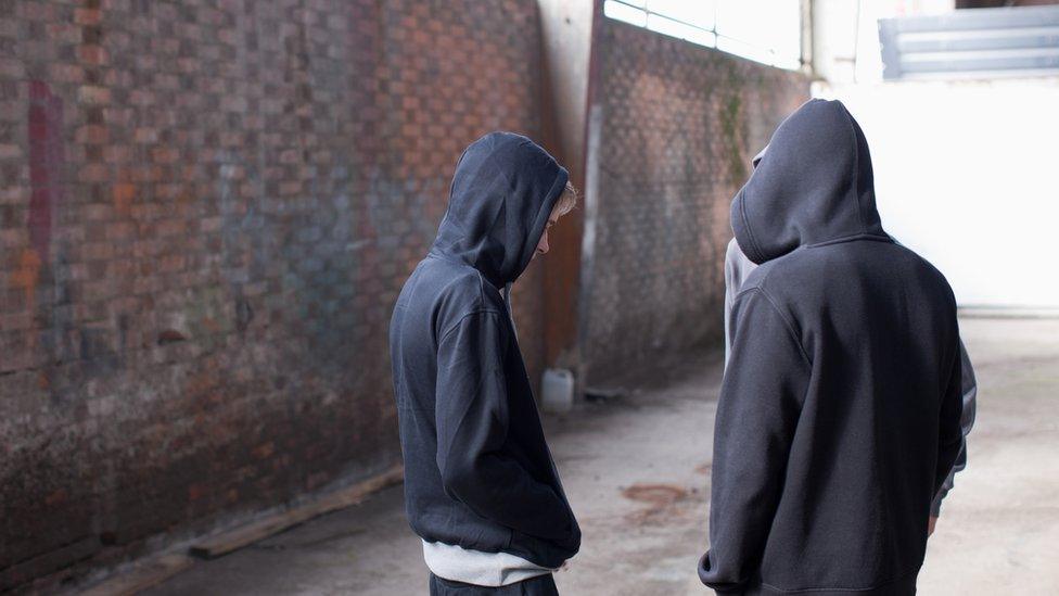 Three men in an abandoned building