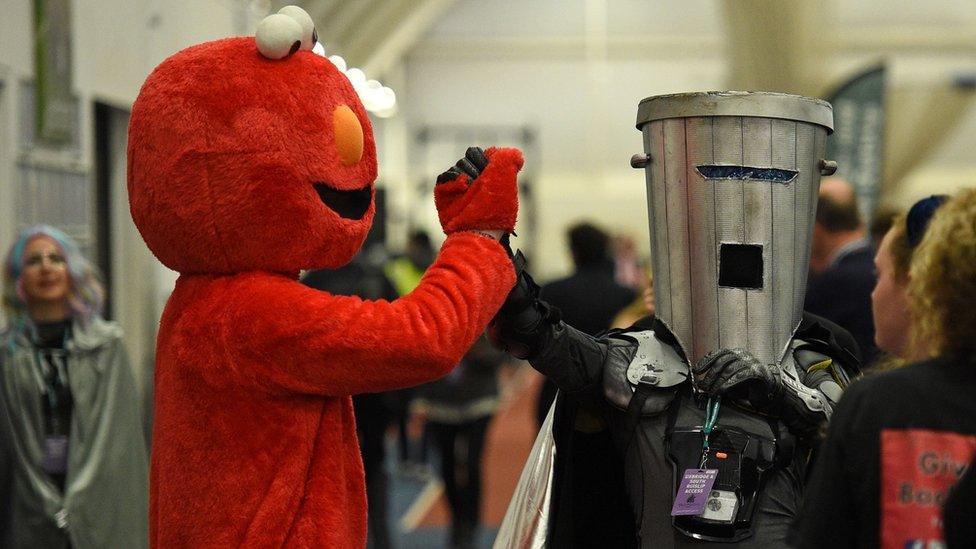 Elmo and Count Binface share a handshake