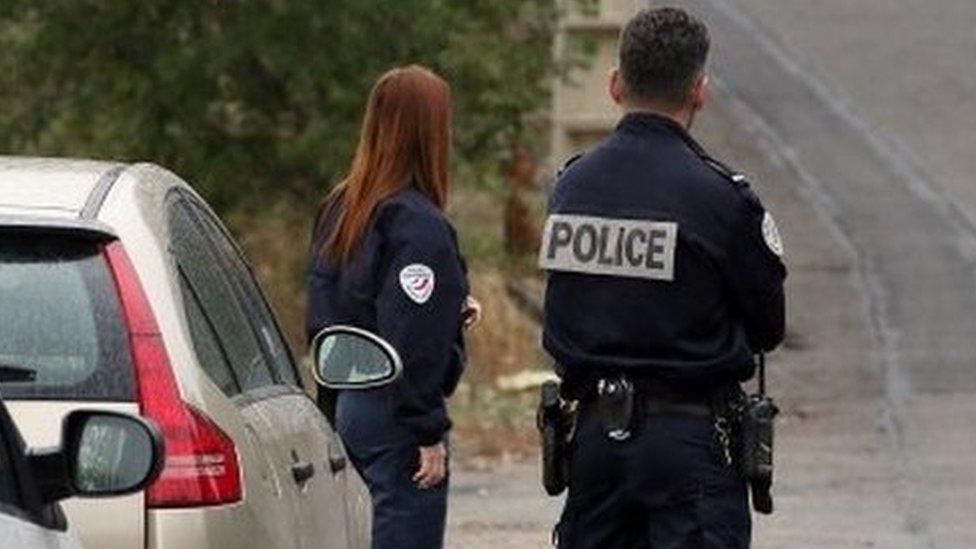 French police officers stand at the scene where Jacqueline Veyrac was found alive two days after being kidnapped