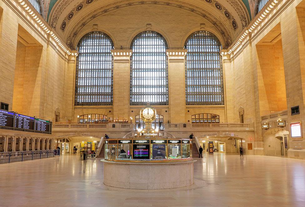 The clock strikes noon at the main concourse of the Grand Central Terminal in Manhattan in New York