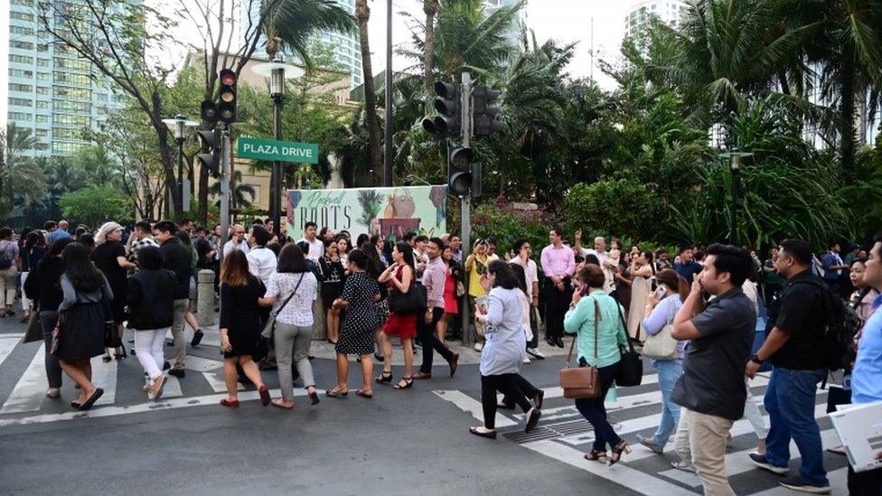 People evacuate a building in Manila