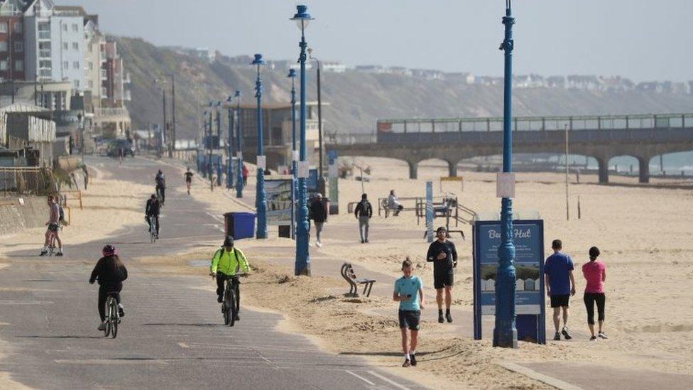 People exercise along the seafront on Boscombe Beach