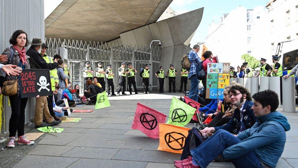 Extinction Rebellion climate change protestors outside the Scottish Parliament, as MSPs on the Environment, Climate Change and Land Reform Committee discuss amendments to the Scottish Government's Climate Change Bill, on June 18, 2019 in Edinburgh, Scotland