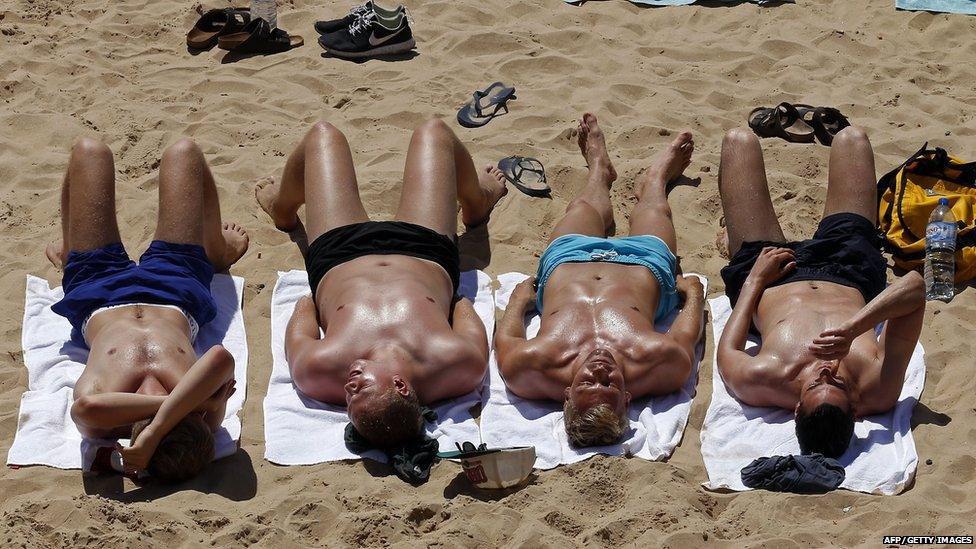 People sunbathing on the beach