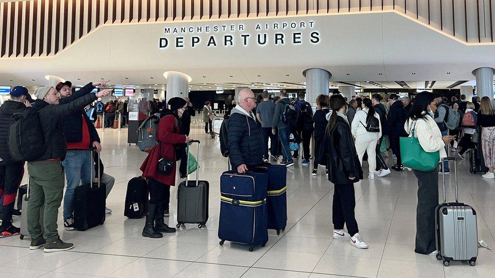 Passengers queuing at Manchester Airport