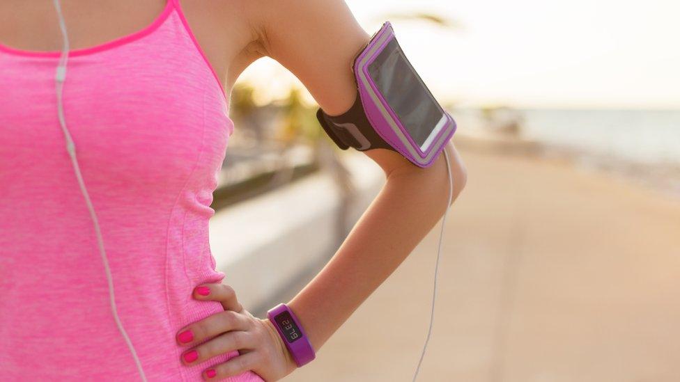 Woman with smartphone and fitness watch