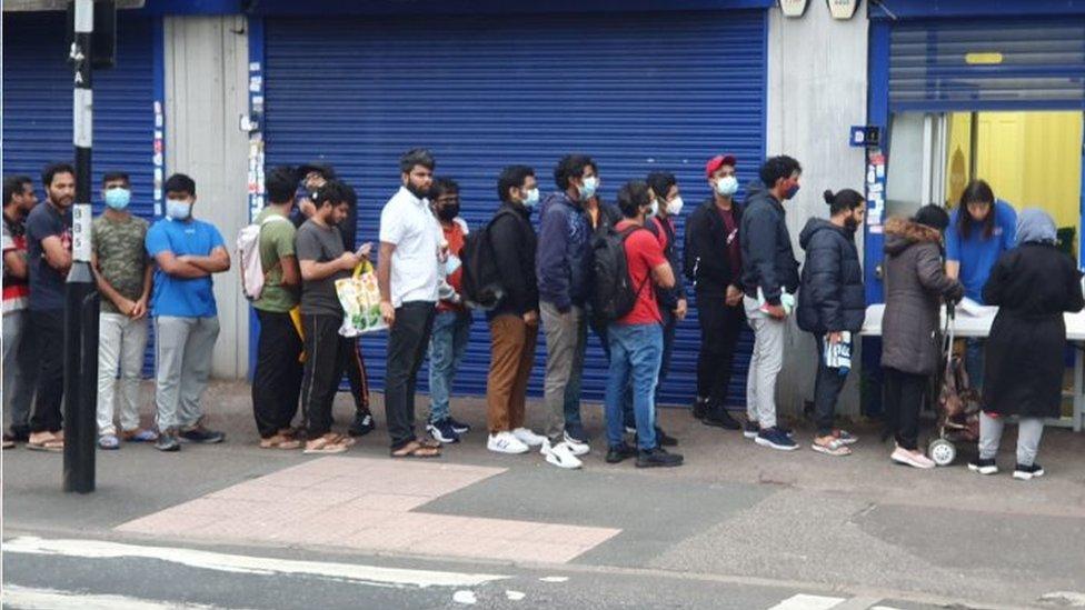 Students queueing outside the Newham Community Project food bank