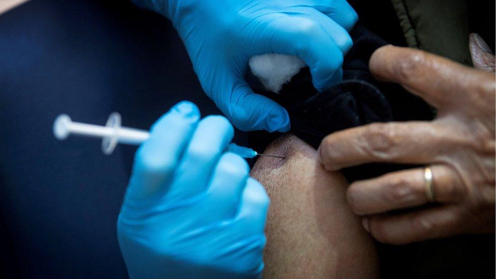 Elderly man receives vaccine