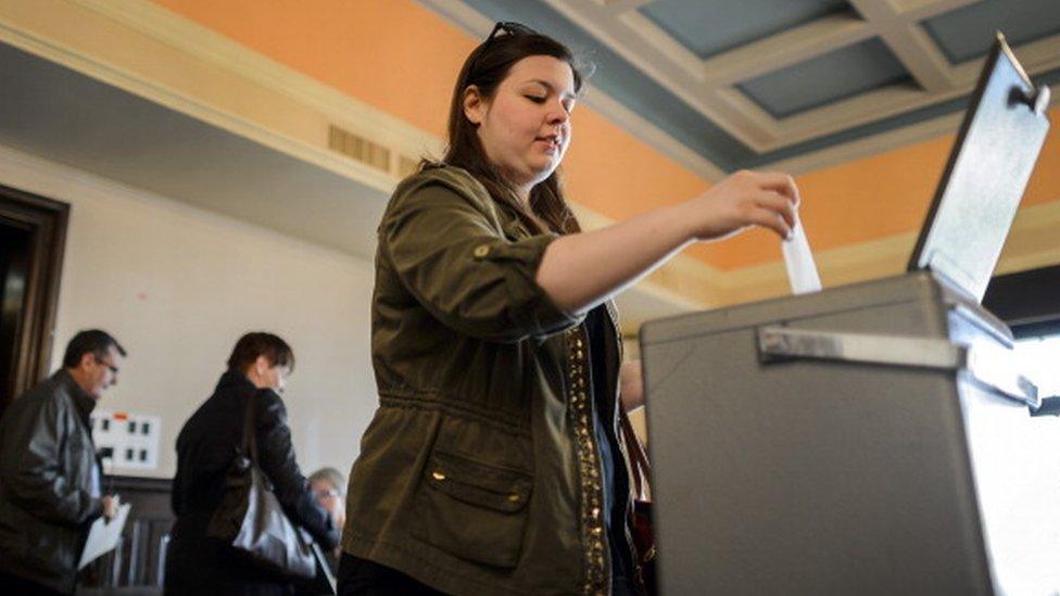 A woman casts her ballot in Switzerland