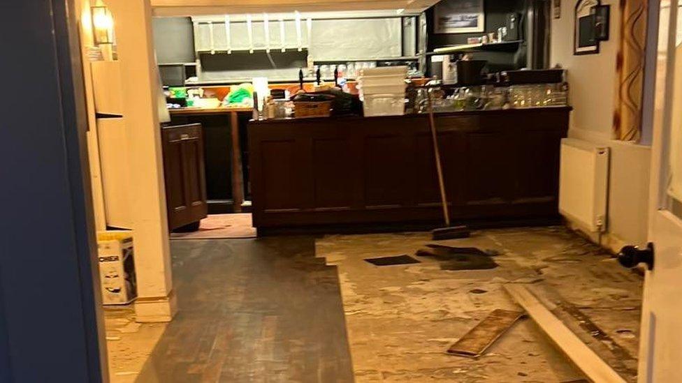 Floorboards lying on a flood-damaged floor