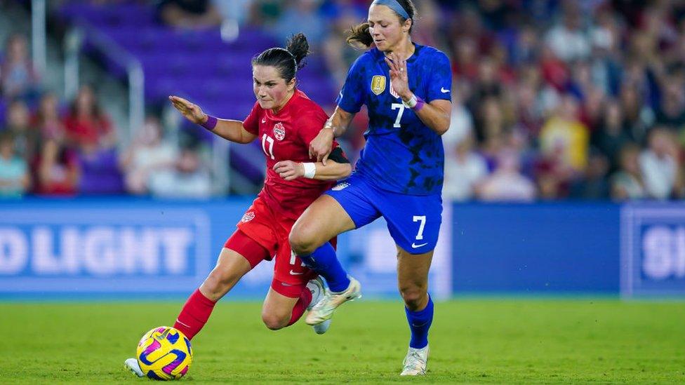 Jessie Fleming #17 of Canada and Ashley Hatch #7 of the United States battle for the ball