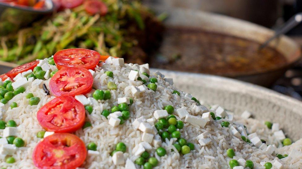 Rice garnished with tomato slices at a food stall in India