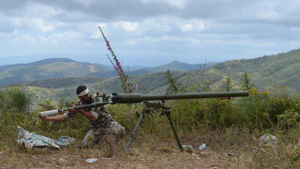 A rebel fighter loads an anti-tank cannon during fighting against pro-government forces on the outskirts of Syria's Mediterranean port city of Latakia, in 2014