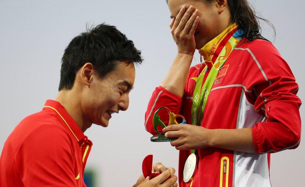 He Zi (CHN) of China recieves a marriage proposal from Olympic diver Qin Kai (CHN) of China after the medal ceremony.