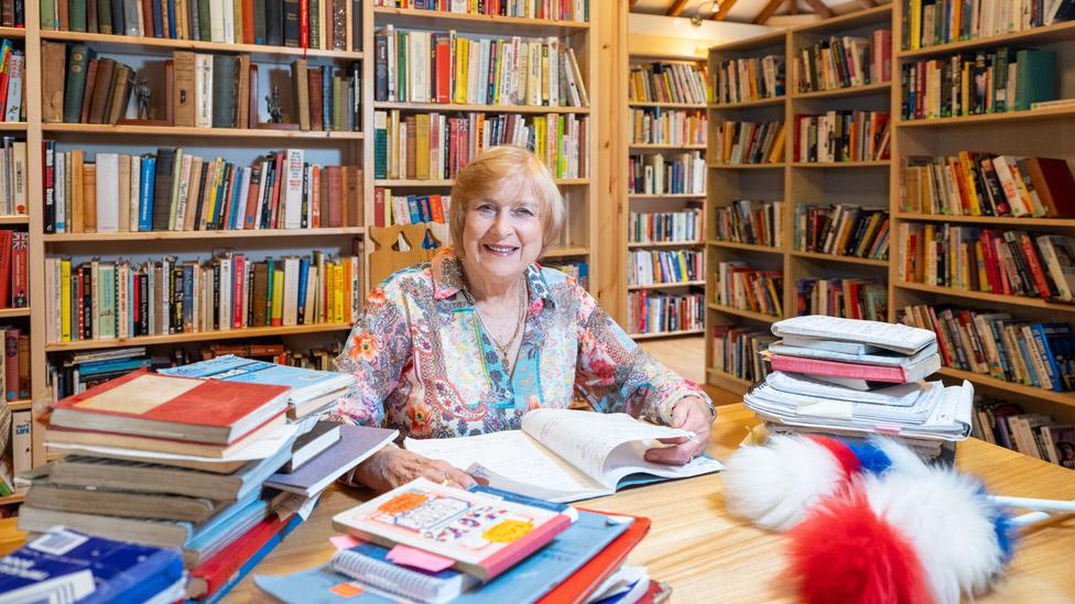 Lady Anne Dodd sitting surrounded by his books and diaries