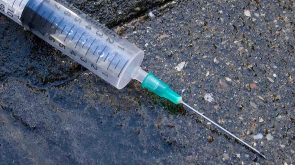 An empty syringe on the ground