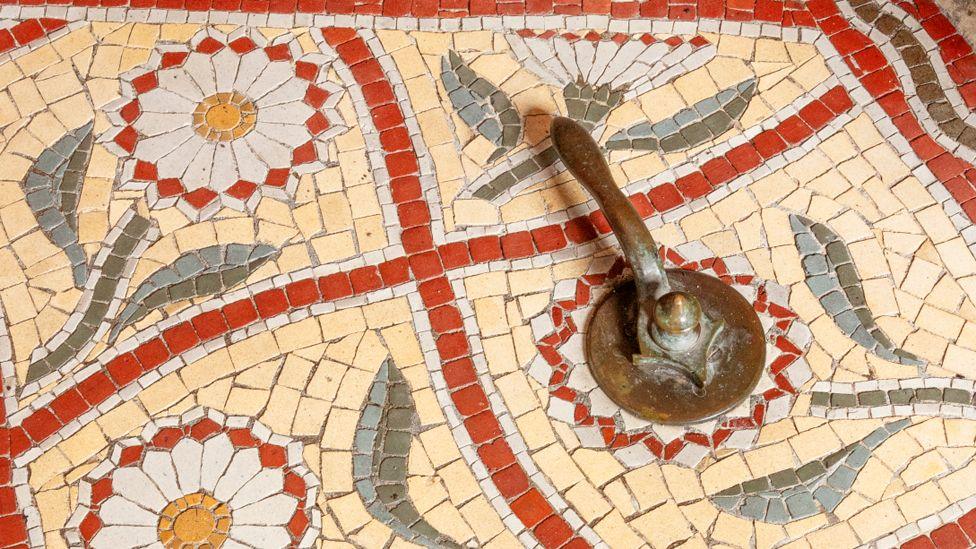 Church of St Anne, St Anne's Drive, Haughton, Denton, Greater Manchester.   Interior, detail of restored mosaic tiles to the north of the font