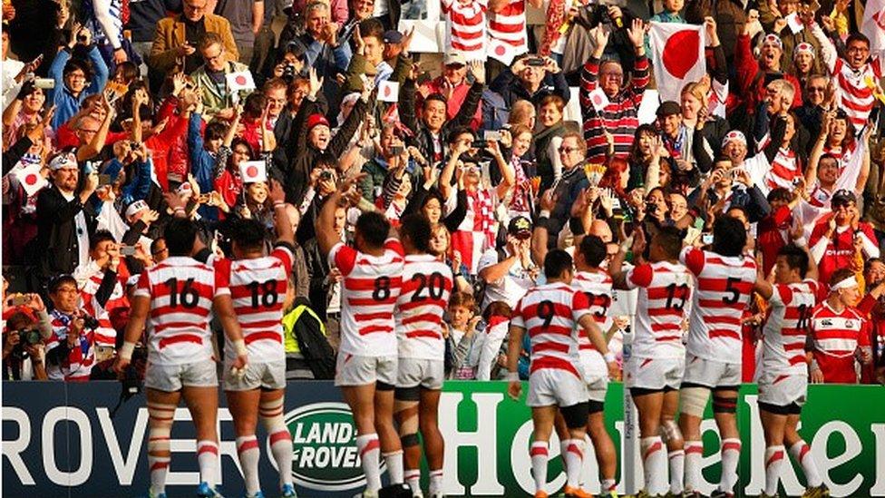 Japan players and fans celebrate after victory over Samoa