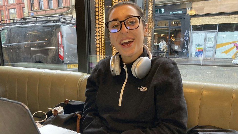 Sofie Matchett smiling at the camera while working from Wilson's Social Club in Northern Quarter.