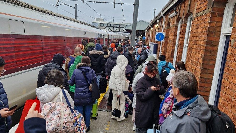 Dozens of passengers on a platform at Grantham station