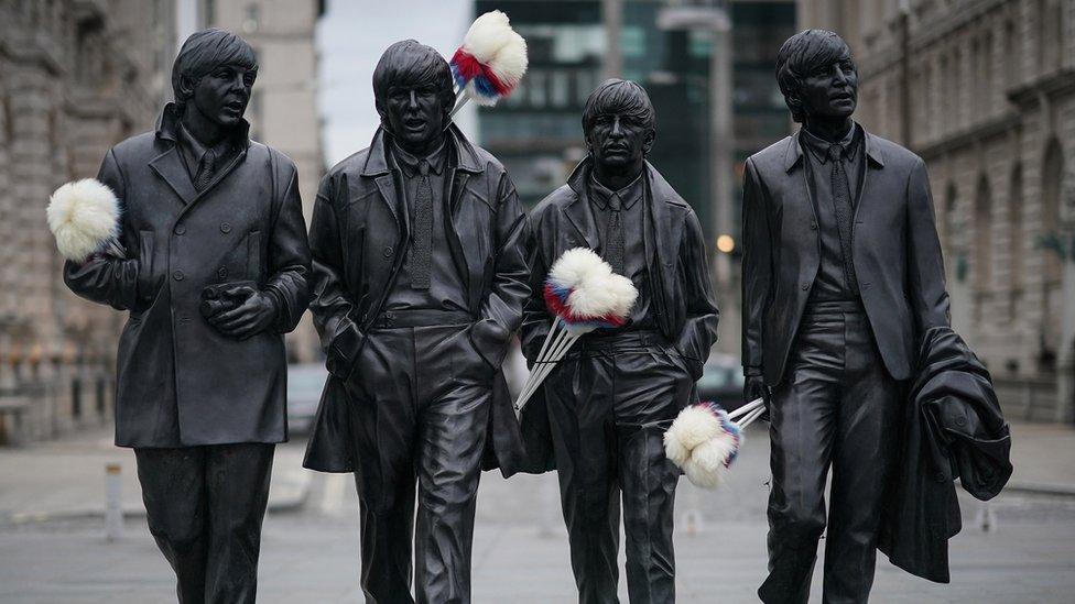 Tickling sticks on The Beatles statue