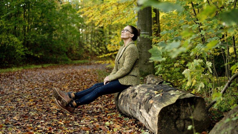 Woman sitting in a forest