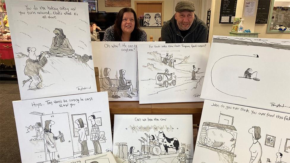 Jackie Francis and Paul Husband with Tony Husband's cartoons