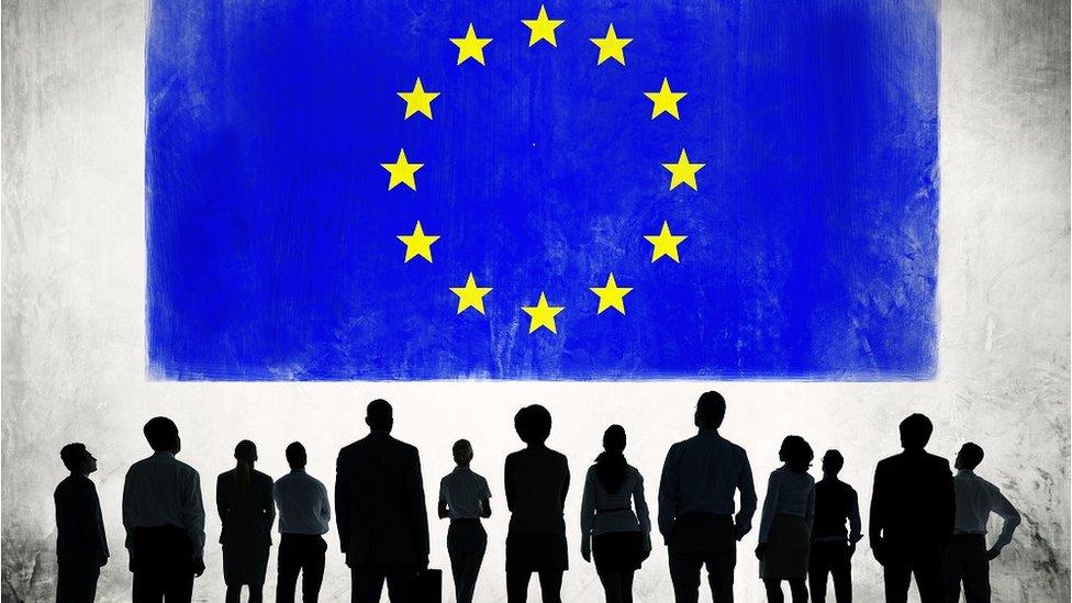 Silhouette of people with flag of European Union