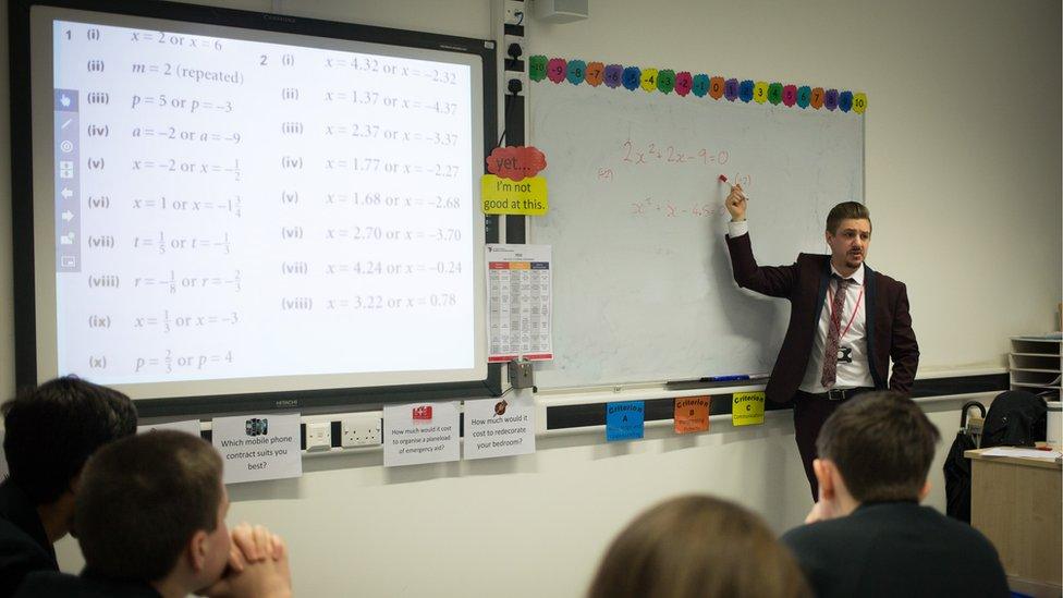 A teacher talks to pupils during a maths lesson at the Ridings Federation Winterbourne International Academy in Winterbourne near Bristol