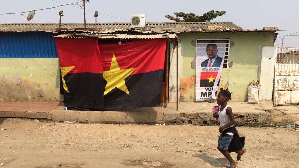 A flag and poster for the ruling party