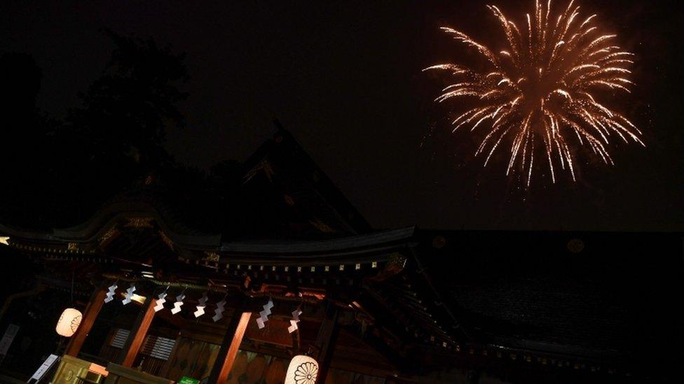 Fireworks explode over the Okunitama shinto shrine in Fuchu in the western suburbs of Tokyo